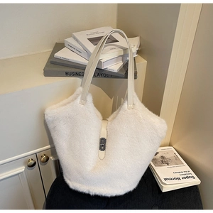 Close-up of white plush tote bag with leather strap and silver metal buckle detail