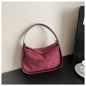 Detail view of burgundy faux suede and leather hobo bag with sleek metal hardware