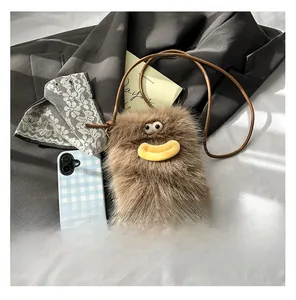 Detailed close-up of brown plush monster bag featuring 3D eyes and yellow sausage lips