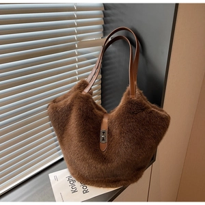 Close-up of dark brown plush tote bag showing soft faux fur texture and metal buckle lock