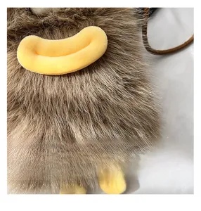 Detail view of brown faux fur phone bag with plush yellow lips and small feet accent