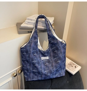 Detail view of purple star pattern tote bag with white rectangular label text