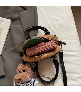 Interior view of the brown suede Boston bag showing space for a phone and wallet