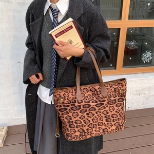 Detailed view of large leopard print tote bag styled with a professional autumn outfit