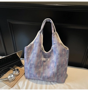 Detail of gradient canvas tote bag with star pattern and Kiss Yourself label