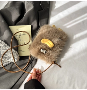 Close-up of brown plush cartoon crossbody bag with fluffy texture and cute duck face