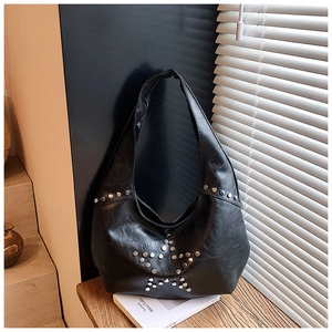 Detail of black Hobo tote bag with silver rivets in a star pattern on faux leather