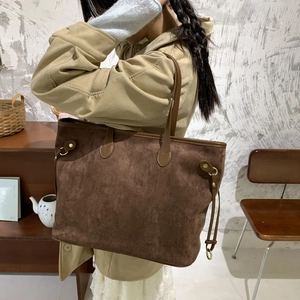 Detail view of the deep brown frosted leather tote bag with vintage drawstring and metal buckle