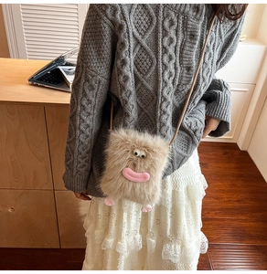 Detail of cute beige plush monster crossbody bag with cartoon eyes and pink feet decor