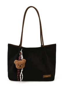 Black frosted suede tote bag with brown straps and cute teddy bear charm on white background