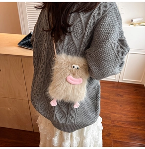 Detail of cute brown plush crossbody bag with monster eyes and small pink feet