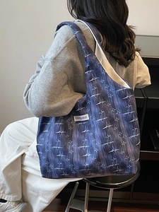 Large navy canvas tote bag with white star pattern and shoulder strap for casual wear