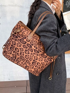 Large leopard print tote bag with brown leather straps shown on model for autumn winter style