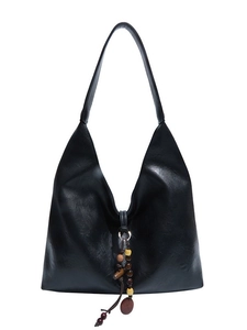 Large black matte leather hobo tote bag with ethnic wood bead tassel on white background