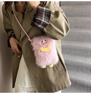 Detail of pink fluffy monster crossbody bag showing long faux fur texture and straps