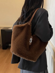Brown faux fur tote bag with leather straps and a metal twist lock for autumn winter