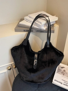 Large black plush faux fur tote bag with long leather straps and silver buckle detail