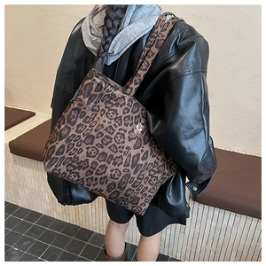 Detail of vintage leopard print tote bag with cute cartoon bear embroidery decoration
