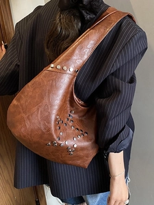 Vintage brown shoulder bag with silver rivet star pattern on glossy leather finish