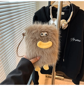 Close-up of a brown plush monster crossbody bag featuring a cute 3D cartoon design
