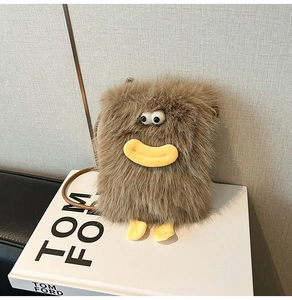 Macro shot of brown faux fur monster crossbody bag with yellow lips and 3D eye details