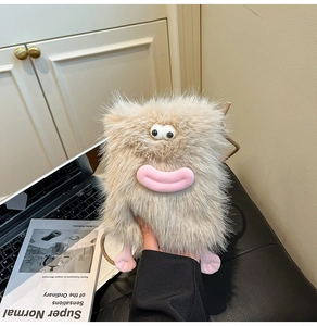 Close-up of fluffy monster plush crossbody bag with pink lips and woven rope strap