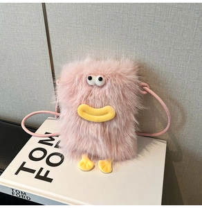 Close-up of pink fluffy monster plush bag with cartoon eyes and yellow duck beak detail