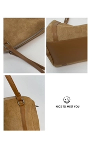 Detail view of brown suede pillow bag showing silver hardware and contrast leather stitching