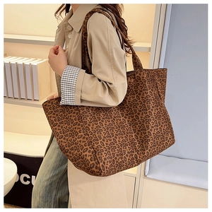 Detailed close-up of a leopard print tote bag with thick fabric and sturdy shoulder straps