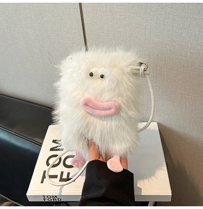 Detail shot of a white fuzzy monster crossbody bag featuring cute pink eyes and feet