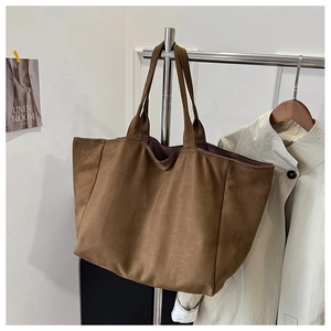 Close-up of a brown leopard print tote bag made of soft suede with dual shoulder straps