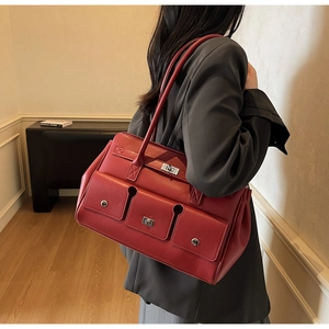 Side view of model wearing a vintage burgundy faux leather tote bag with pocket details