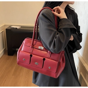Macro detail of retro burgundy leather tote with structured silver twist-lock and pockets