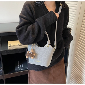 Grey PU leather bucket bag with leopard print and a cute plush monster charm detail
