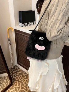 Cute black plush crossbody bag featuring cartoon monster eyes and soft faux fur texture