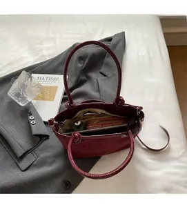 Top view of burgundy bucket bag interior showing spacious compartments for wallet and phone