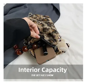 Detailed interior of leopard print plush bucket bag showing phone and lipstick storage