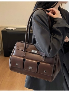 Vintage brown leather shoulder bag with triple front pockets and silver twist locks
