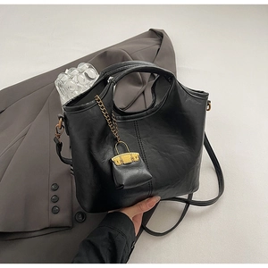 Détail du sac cabas en cuir PU noir souple avec chaîne dorée et bandoulière réglable