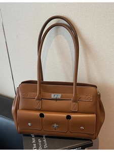 Retro caramel brown leather tote bag with multi-pocket design and silver buckles