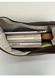 Top-down view of spacious dark brown leather shoulder bag interior showing large storage capacity