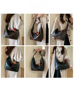 Hobo shoulder bag styling options in dark brown and black with plush charm detail