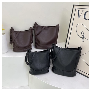 Detailed comparison of large and small bucket bags in premium lychee grain leather finish
