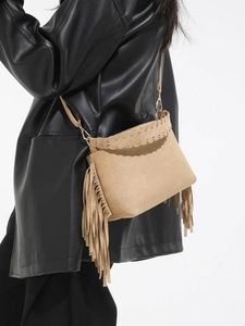 Frosted khaki crossbody bag with long tassels and leather woven trim on a fashion model