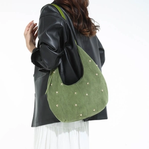 Dettaglio borsa hobo in pelle scamosciata verde oliva con rivetti dorati lucidi