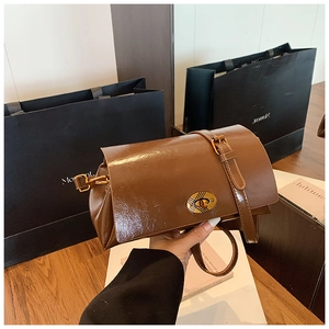 Détail du sac en cuir ciré marron avec fermoir vintage en bronze à rayures ovales