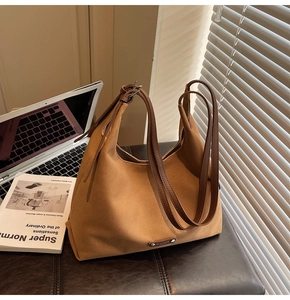 Brown canvas tote bag on chair next to a laptop in a modern minimalist home office