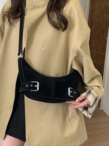 Minimalist black hobo shoulder bag in matte suede with decorative silver buckles