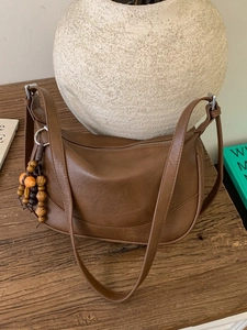 Retro brown leather hobo bag with unique wooden bead charm and zip closure