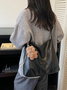 Retro black faux leather tote bag with plush dog pendant for stylish daily commuting